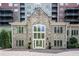 Striking stone facade with expansive windows and balcony views in a luxurious residential building at 3280 Stillhouse Se Ln # 108, Atlanta, GA 30339