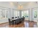 Bright dining room with hardwood floors, multiple windows, and elegant drapery at 3280 Stillhouse Se Ln # 108, Atlanta, GA 30339
