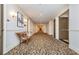 Hallway featuring carpet with a floral pattern, lights and a bench at 3280 Stillhouse Se Ln # 108, Atlanta, GA 30339