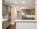 Modern kitchen featuring stainless steel appliances, a breakfast bar, and hardwood floors at 3280 Stillhouse Se Ln # 108, Atlanta, GA 30339