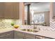 Open-concept kitchen showcasing elegant countertops and backsplash, complemented by views into the adjoining living space at 3280 Stillhouse Se Ln # 108, Atlanta, GA 30339
