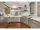 Modern kitchen with stainless steel appliances, herringbone backsplash, and ample counter space, perfect for cooking at 3280 Stillhouse Se Ln # 108, Atlanta, GA 30339