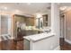 Spacious kitchen with stainless steel appliances, gray cabinetry, and a breakfast bar overlooking the dining area at 3280 Stillhouse Se Ln # 108, Atlanta, GA 30339