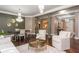 Elegant living room featuring hardwood floors, pillars, chandelier and neutral color palette at 3280 Stillhouse Se Ln # 108, Atlanta, GA 30339
