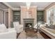 Chandeliered living room with fireplace, bookshelves, and hardwood floors at 3280 Stillhouse Se Ln # 108, Atlanta, GA 30339