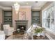 Cozy living room with a fireplace, built-in shelves, and plush seating under chandelier at 3280 Stillhouse Se Ln # 108, Atlanta, GA 30339