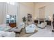An elegant living room has a fireplace, lots of seating and lots of natural light at 3280 Stillhouse Se Ln # 108, Atlanta, GA 30339
