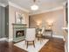 Cozy living room with a fireplace, hardwood floors, and elegant decor with a center rug at 3280 Stillhouse Se Ln # 108, Atlanta, GA 30339