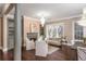 Chandeliered living area with hardwood floors, built in bookshelves, fireplace, and seating at 3280 Stillhouse Se Ln # 108, Atlanta, GA 30339