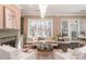 Living room boasting a chandelier, large windows, fireplace, and stylish seating arrangement at 3280 Stillhouse Se Ln # 108, Atlanta, GA 30339