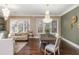 Open living space with chandeliers, dining table, living room set, hardwood floors at 3280 Stillhouse Se Ln # 108, Atlanta, GA 30339