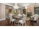 Open living and dining space with modern decor, a column, and hardwood floors at 3280 Stillhouse Se Ln # 108, Atlanta, GA 30339