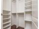 Bright walk-in closet with custom shelving and hanging rods for optimal organization at 3280 Stillhouse Se Ln # 108, Atlanta, GA 30339