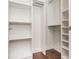Spacious walk-in closet with white shelving and wooden floors, providing ample storage space at 3280 Stillhouse Se Ln # 108, Atlanta, GA 30339