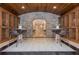 Unique wine cellar with stone archway, custom cabinets, and stylish tile flooring at 3280 Stillhouse Se Ln # 108, Atlanta, GA 30339