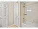 Bathroom featuring a tub-shower combination and a white tile surround at 4248 River Green Nw Dr # 310, Atlanta, GA 30327