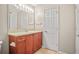 Bathroom with a single sink, wood cabinets, and a large mirror at 4248 River Green Nw Dr # 310, Atlanta, GA 30327