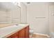 Well-lit bathroom featuring a single sink vanity with wood cabinets and a large mirror over the sink at 4248 River Green Nw Dr # 310, Atlanta, GA 30327