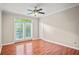 The bedroom has wood floors, neutral paint, a ceiling fan and doors leading to the balcony at 4248 River Green Nw Dr # 310, Atlanta, GA 30327