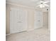 Neutral bedroom with a ceiling fan, carpet, and two closet doors at 4248 River Green Nw Dr # 310, Atlanta, GA 30327