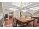 Elegant dining room with mirrored walls, hardwood floors, and a sophisticated chandelier at 4248 River Green Nw Dr # 310, Atlanta, GA 30327