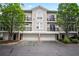 Townhouse with multiple balconies and garages offering a blend of style and functionality at 4248 River Green Nw Dr # 310, Atlanta, GA 30327