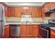 Well-lit kitchen features stainless steel appliances, light countertops, and wood cabinets at 4248 River Green Nw Dr # 310, Atlanta, GA 30327