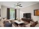 Bright living room features neutral decor, a ceiling fan, balcony access and comfortable seating at 4248 River Green Nw Dr # 310, Atlanta, GA 30327