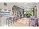 Community lounge featuring sleek bar with granite counters, coffered ceilings, and an array of seating options at 4248 River Green Nw Dr # 310, Atlanta, GA 30327