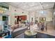Community lounge area features a modern sofa, stylish furniture, high ceilings, and an eat-in kitchen in the background at 4248 River Green Nw Dr # 310, Atlanta, GA 30327