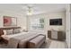 Cozy main bedroom with a ceiling fan, large window, and neutral color palette at 4248 River Green Nw Dr # 310, Atlanta, GA 30327