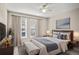 Comfortable main bedroom with large windows and a ceiling fan at 4248 River Green Nw Dr # 310, Atlanta, GA 30327