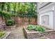Charming stone patio featuring lush landscaping and decorative wall features, creating a serene outdoor retreat at 4248 River Green Nw Dr # 310, Atlanta, GA 30327