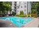 Community swimming pool surrounded by lounge chairs and trees, perfect for summer relaxation at 4248 River Green Nw Dr # 310, Atlanta, GA 30327