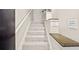 Well-lit staircase with carpeted steps and handrail, ensuring safe passage between floors at 4248 River Green Nw Dr # 310, Atlanta, GA 30327