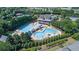Aerial view of community amenities: tennis courts, swimming pool, clubhouse amidst lush greenery at 7615 Laurel Oak Dr, Suwanee, GA 30024