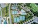 Aerial view featuring tennis courts, swimming pool, clubhouse, and golf course at 7615 Laurel Oak Dr, Suwanee, GA 30024