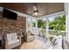 Cozy covered porch with wicker furniture, ceiling fan, and brick siding at 7615 Laurel Oak Dr, Suwanee, GA 30024