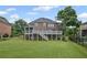 Spacious backyard with a deck, patio, and a well-manicured lawn at 7615 Laurel Oak Dr, Suwanee, GA 30024
