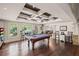Finished basement featuring a pool table, coffered ceilings, hardwood floors, and a sitting area at 7615 Laurel Oak Dr, Suwanee, GA 30024