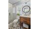 Stylish bathroom with a glass-enclosed shower, patterned floor tiles, and a wood vanity with a vessel sink at 7615 Laurel Oak Dr, Suwanee, GA 30024