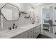 Updated bathroom featuring dual sinks, quartz countertops, dark fixtures, and modern decor at 7615 Laurel Oak Dr, Suwanee, GA 30024