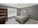 Cozy bedroom with gray walls, large window, and built in bookcase that provides practical storage at 7615 Laurel Oak Dr, Suwanee, GA 30024