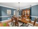 Dining room featuring a table set for dinner with a chandelier and blue painted walls at 7615 Laurel Oak Dr, Suwanee, GA 30024