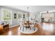 Bright dining room with hardwood floors, decorative lighting and large windows at 7615 Laurel Oak Dr, Suwanee, GA 30024