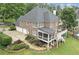 Beautiful brick home featuring a basketball court, spacious deck, screened porch, and lush landscaping at 7615 Laurel Oak Dr, Suwanee, GA 30024