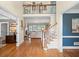 Open foyer with hardwood floors, a staircase, and views of a living room and blue accented room at 7615 Laurel Oak Dr, Suwanee, GA 30024