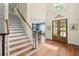 Foyer with staircase, hardwood floors, and view of the dining room at 7615 Laurel Oak Dr, Suwanee, GA 30024