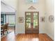 Elegant foyer featuring hardwood floors, a glass paneled double door, and decorative wall art at 7615 Laurel Oak Dr, Suwanee, GA 30024