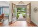 Grand foyer featuring hardwood floors, a decorative mirror, and double doors leading to a landscaped front yard at 7615 Laurel Oak Dr, Suwanee, GA 30024